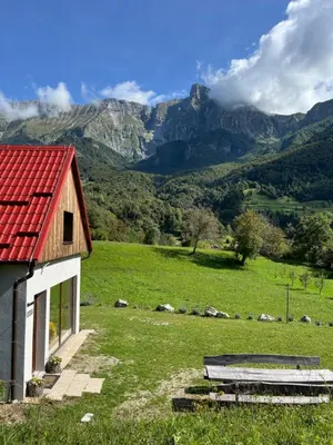 a house with a red roof on a green field at Holiday home Dreams in Kobarid