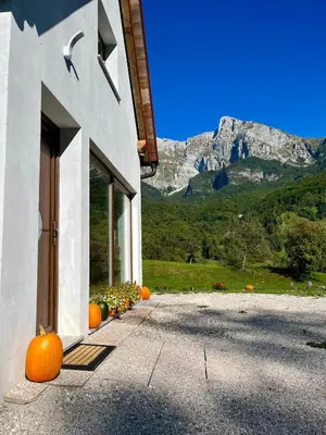a house with pumpkins outside of it with a mountain at Holiday home Dreams in Kobarid