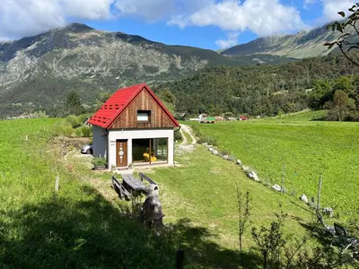 a small house with a red roof in a field at Holiday home Dreams in Kobarid