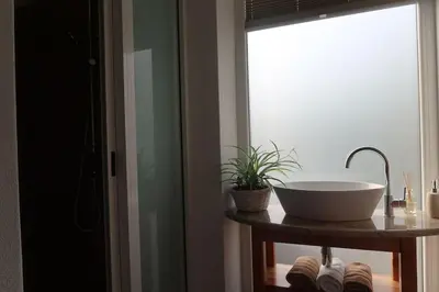 a bathroom with a bowl sink and a window at Holiday home Dreams in Kobarid