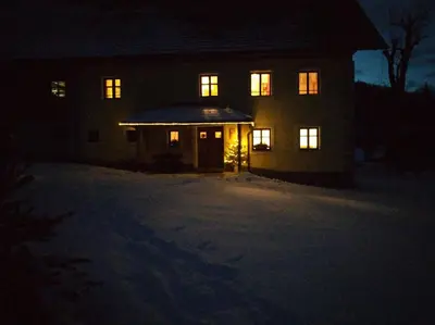 a house at night with its lights on at Apartments Čumar in Cerkno