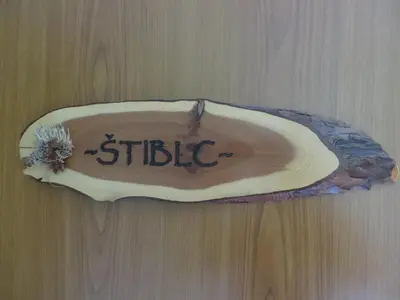 a wooden table with a shell with the word stifle on it at Country House Apat in Šoštanj