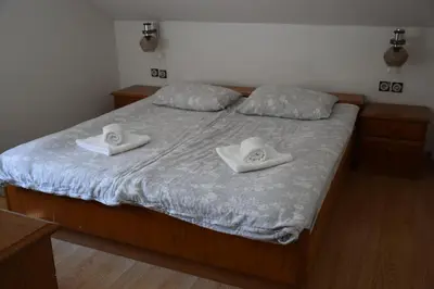 a bed with two white towels on top of it at Apartma narava in Begunje pri Cerknici