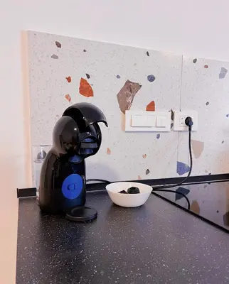 a black mixer sitting on top of a counter at Aumetz square apartment in Idrija
