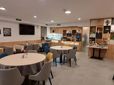 a restaurant with tables and chairs and a counter at Boutique Hotel Vila Loka in Škofja Loka