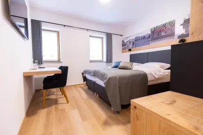 a bedroom with a bed and a desk in it at Boutique Hotel Vila Loka in Škofja Loka