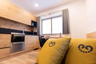 a living room with a yellow couch in a kitchen at Boutique Hotel Vila Loka in Škofja Loka