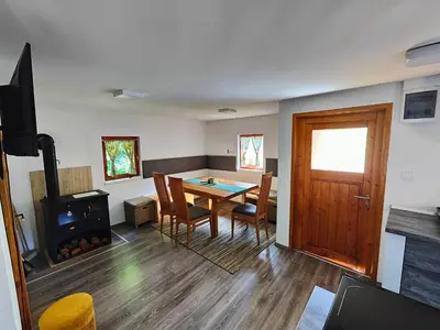 a living room with a table and a fireplace at Holiday Home Sveti Martin in Kobilje