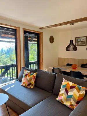 a living room with a couch and a table at Apartments Pri Fencu in Jesenice