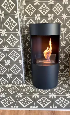 a fireplace with a fire in it on a wall at Apartments Pri Fencu in Jesenice