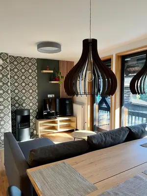 a living room with a couch and a table at Apartments Pri Fencu in Jesenice