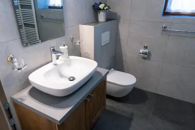 a bathroom with a sink and a toilet at Apartma pr' Gamilcu in Tolmin