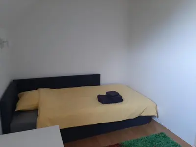a bed in a room with a black shirt on it at Hisa Haasberg in Planina
