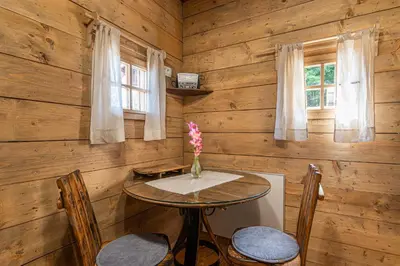 a dining room with a table and two chairs at Glamping Paradise Škatlar in Otočec