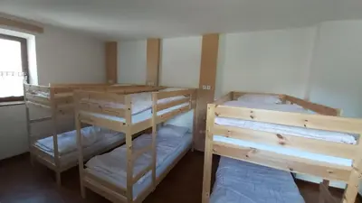 two bunk beds in a room with a window at Hostel in picerija Špajza in Mojstrana