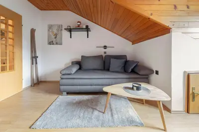 a living room with a couch and a table at Apartma Alpine Space, Kranjska Gora - Center in Kranjska Gora