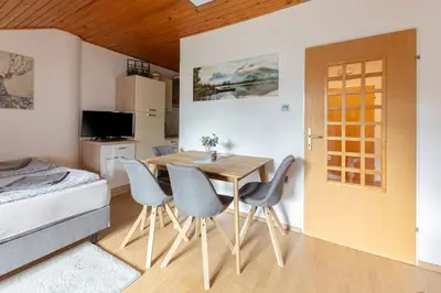 a dining room with a table and chairs in a room at Apartma Alpine Space, Kranjska Gora - Center in Kranjska Gora