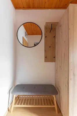a room with a bench and a mirror at Apartma Alpine Space, Kranjska Gora - Center in Kranjska Gora