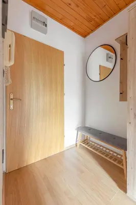 a room with a wooden door and a mirror at Apartma Alpine Space, Kranjska Gora - Center in Kranjska Gora