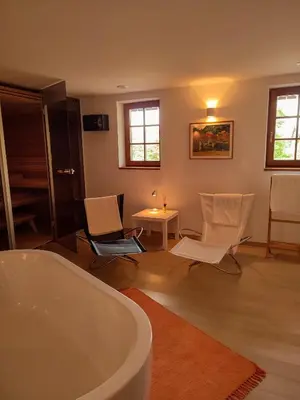 a bathroom with a tub and chairs and a table at Old Taylor's house in Gradac