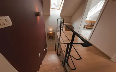a staircase in a home with a black railing at Old Taylor's house in Gradac