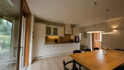 a kitchen and dining room with a wooden table at Old Taylor's house in Gradac