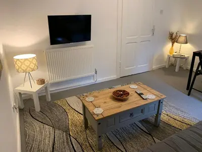 a living room with a coffee table and a tv at Apartment Yiorgos in Bovec