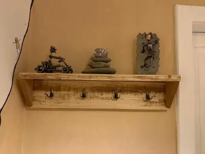 a shelf on a wall with some items on it at Apartment Yiorgos in Bovec