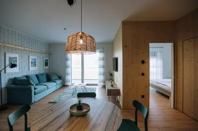 a living room with a table and a couch at Postcard Country Apartments in Spodnji Duplek
