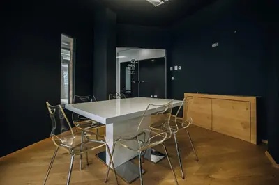 a kitchen with a table and chairs and a mirror at Postcard Country Apartments in Spodnji Duplek
