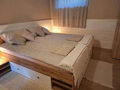 a bed with two pillows on it in a room at Hiša odprtih vrat in Tolmin