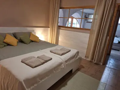 a bedroom with a bed with two towels on it at Hiša odprtih vrat in Tolmin