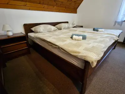 a bedroom with a bed with two candles on it at Rooms MARETČ in Bohinj