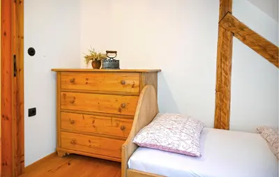 a bedroom with a dresser and a wooden dresser at 2 Bedroom Stunning Apartment In Mozirje in Mozirje