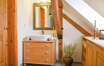 a bathroom with a sink and a mirror on a dresser at 2 Bedroom Stunning Apartment In Mozirje in Mozirje