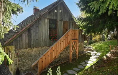 a house with a wooden staircase leading to it at 2 Bedroom Stunning Apartment In Mozirje in Mozirje