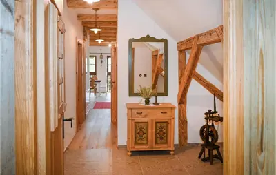 a hallway with a mirror and a wooden dresser at 2 Bedroom Stunning Apartment In Mozirje in Mozirje