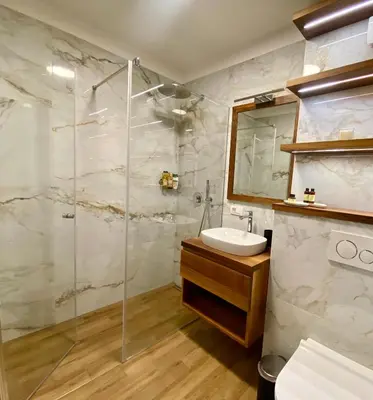 a bathroom with a sink and a shower at Olimian Retreat Rosa 421 in Podčetrtek