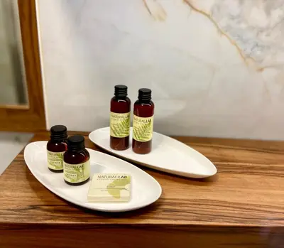 two white plates with two bottles of honey on them at Olimian Retreat Rosa 421 in Podčetrtek