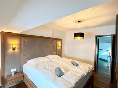a bedroom with a large bed with two pillows on it at Olimian Retreat Rosa 421 in Podčetrtek
