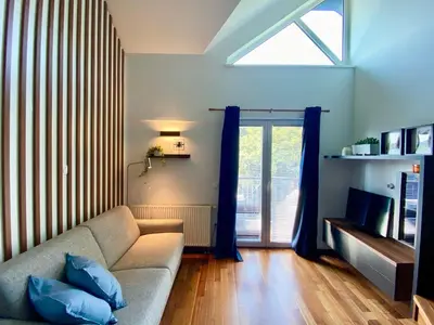 a living room with a couch and a window at Olimian Retreat Rosa 421 in Podčetrtek