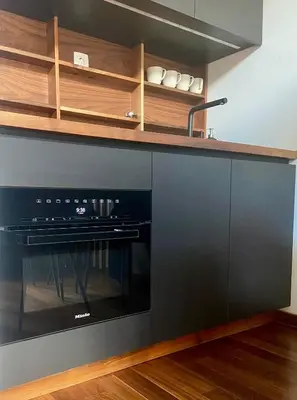 a kitchen with a black oven and a sink at Olimian Retreat Rosa 421 in Podčetrtek