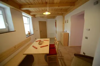 a small room with a wooden table and chairs at Apartments Mojca in Bled