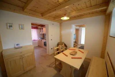 a kitchen and dining room with a table and a counter at Apartments Mojca in Bled