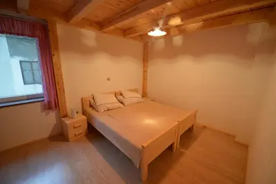 a bedroom with a bed in a room with a window at Apartments Mojca in Bled