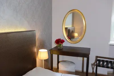 a bedroom with a table and a mirror at B&B Castanea in Kostanjevica na Krki