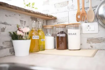a counter with several bottles of liquid on a shelf at Duplex Apartma Nikolina in Spodnje Jarše