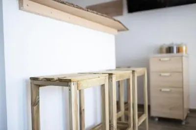 a wooden table in a kitchen with a counter at Duplex Apartma Nikolina in Spodnje Jarše