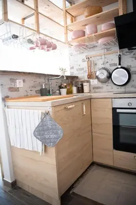 a kitchen with wooden cabinets and a stove at Duplex Apartma Nikolina in Spodnje Jarše
