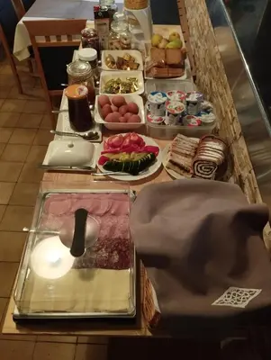 a buffet with different types of food on a table at Guest House Kmečki Hram FORTUNA in Idrija